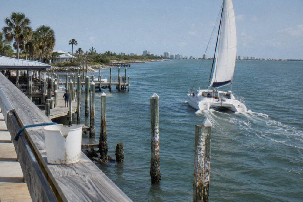 A small sailing catamaran under way on open lagoon water
