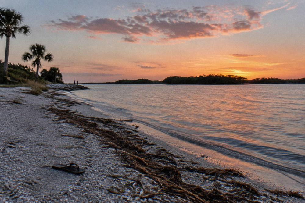 Sunset colors over a wide Florida lagoon with silhouetted mangrove islands