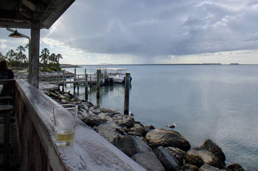 Storm clouds building over calm lagoon water near Cocoa Beach shoreline